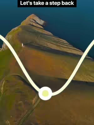 An aerial shot of a mountain range with a water body in the background. The image has a wave-like line overlaid on it.