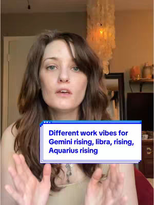A woman with brown hair and light skin is centered in the frame, appearing to be in her home. She is wearing a light-colored top. A text overlay in a blue box with a white border at the bottom, with the text reading, "Different work vibes for Gemini rising, libra, rising, Aquarius rising."