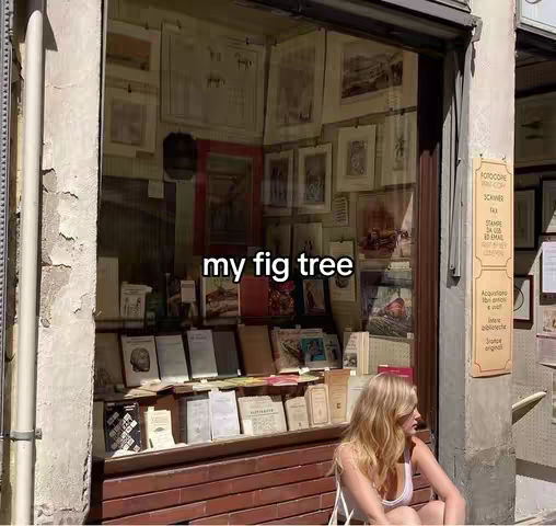 A young woman sits outside a shop filled with books and artwork, with text overlayed on the image.