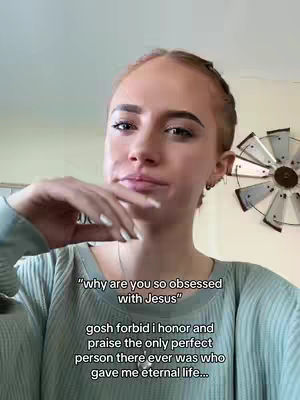 A woman with light skin and long reddish hair, pulled back from her face except for some loose pieces. She's wearing a light green sweater and holding her hand up near her face, with the fingertips touching her lips. Text is overlaid on the image in a casual font.