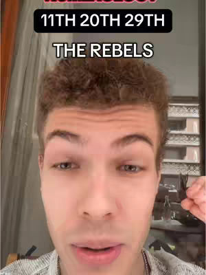 The cover image shows a young man with short brown hair and a light complexion, centered in the frame. The background is slightly out of focus, suggesting an indoor setting. Above his head, there is a text overlay in white font on a black background, which states "11TH 20TH 29TH" on the first line and "THE REBELS" on the second line. The man appears to be looking directly at the camera with a neutral expression. The lighting seems to be soft and diffused.