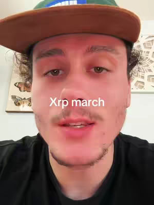 A man with a hat and a black shirt stares directly at the camera. Text saying 'Xrp march' is overlaid on the image.