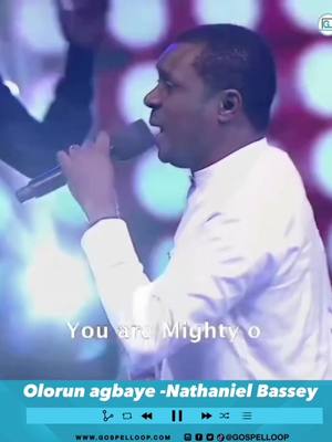 The cover image features a man singing into a microphone. He is wearing a white collared shirt and appears to be on a stage with an audience in the background. Text overlays include the song title and artist information with a GospelLoop logo.