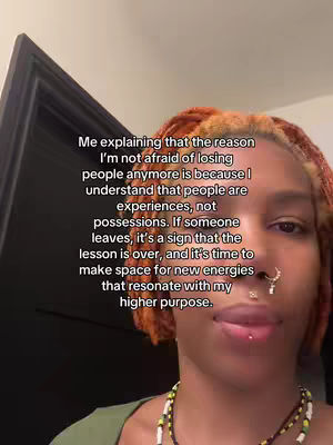 A selfie-style shot featuring a person with reddish-brown and orange dreadlocks, adorned with multiple nose piercings. The person is looking at the camera and a text overlay is present.