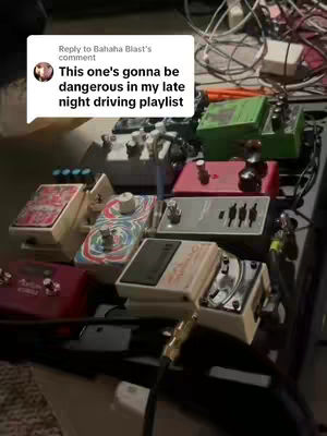 The image is a close-up of a collection of effects pedals. The pedals are various shapes and sizes, with a mix of metallic and colorful casings, arranged closely together on a black surface. Cables and power supplies are visible, indicating a setup for music performance or recording. A speech bubble with text is added to the image.