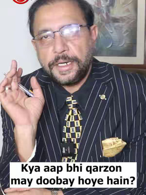 A middle-aged man wearing glasses and a suit is the primary focus, set against an interior backdrop with a painting. The composition centers tightly on his upper body, with a focus on his face as he appears to be speaking. Below, a white rectangular text bar presents a question.