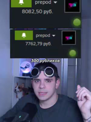 A man wearing steampunk goggles is in the foreground, the image is a selfie style, focusing on his face and upper body. In the background are two Steam interface windows showing account balance, and a small bookshelf. The image is well-lit with natural light.