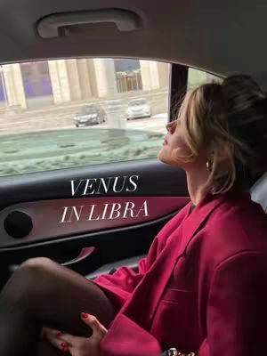 The cover image features a woman inside a car, looking out the window. The dominant colors are red, seen in the woman's blazer and the interior of the car, and the background is a cityscape with soft lighting. The layout is well-composed to draw the viewer's eye towards the woman and the added text.