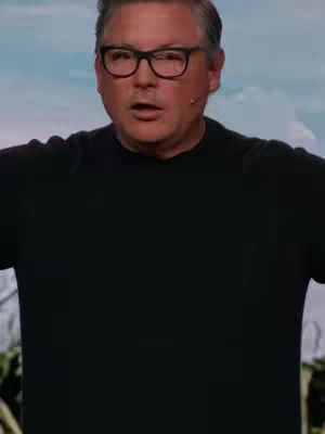 The cover image features a man wearing glasses and a black shirt, set against a blurred background. He is looking directly at the camera with a slight expression, suggesting a discussion or presentation.