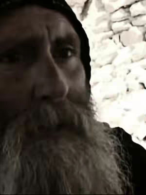The cover image shows a close-up of a man with a long, white beard, a dark hat, and a serious expression. The background appears to be a stone wall.
