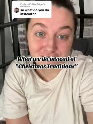 A woman with fair skin and light-colored eyes is centered in the frame, with text overlaid at the bottom of the screen. She's wearing a simple white t-shirt, and the lighting appears to be natural, possibly from indoor ambient light. Behind her, a glimpse of a dark metal structure is visible, but the focus is primarily on the woman's face and the overlaid text.