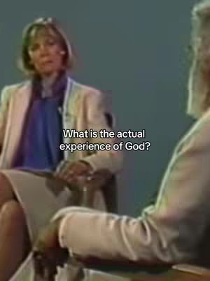 The cover image shows a medium shot of a woman and a man sitting in chairs, likely engaged in an interview or discussion. The woman is the focus, wearing a light-colored jacket with a blue top, appearing to be the interviewer. She is seated on the left, facing slightly to the right. The man is partially visible on the right side, also in light-colored clothing, and leaning forward. Text overlayed on the image asks, 'What is the actual experience of God?'