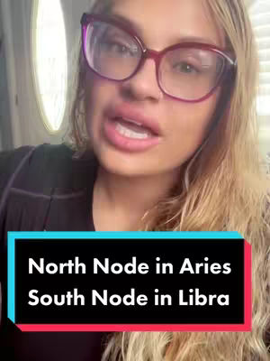 A woman with blonde hair and large pink-rimmed glasses is featured speaking directly to the camera. Text overlay, a black rectangle with a red band at the bottom, states 'North Node in Aries South Node in Libra'