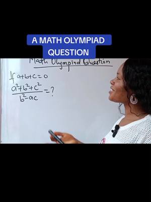 A woman is standing in front of a whiteboard, which has a math question written on it. Above the math problem, there is text that says "A Math Olympiad Question" in a blue box. The woman is wearing a white top and has a microphone clipped to it. She is holding a pen or marker.