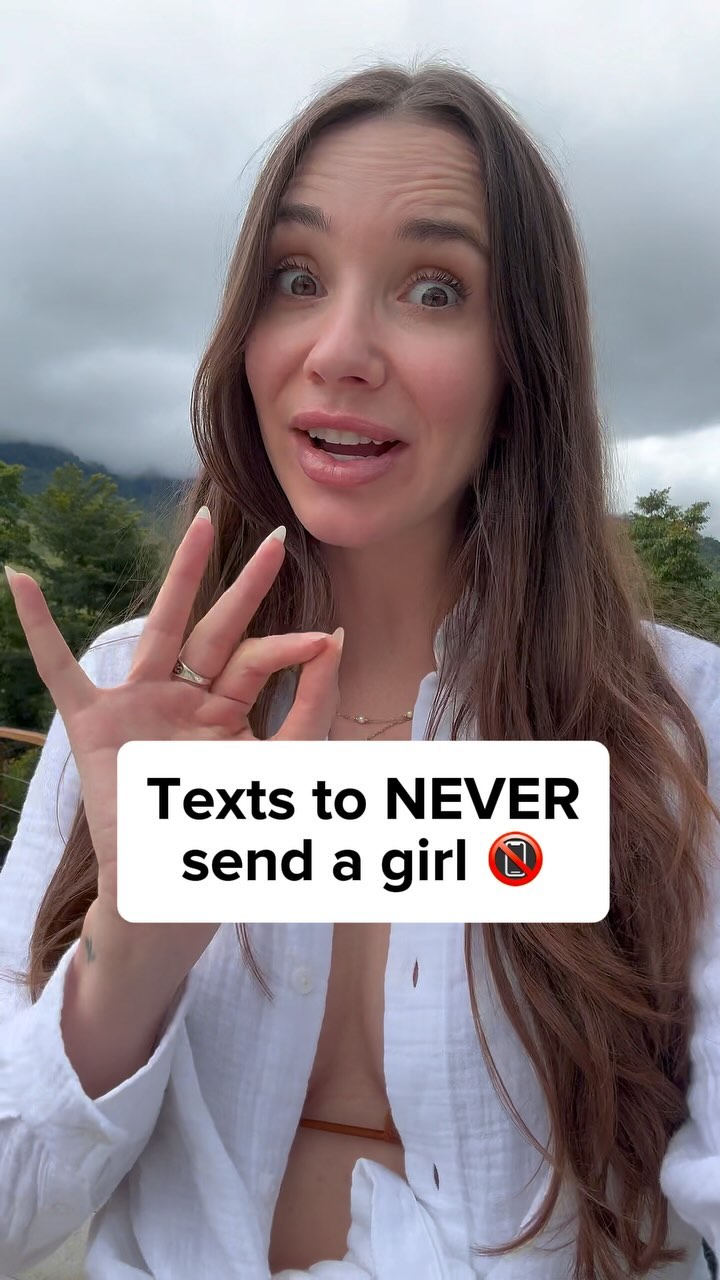 A woman with long brown hair is smiling and making an 'ok' gesture with her hand. Overlaid on the image is a white rectangle with black text that reads 'Texts to NEVER send a girl' along with a no-phone symbol.