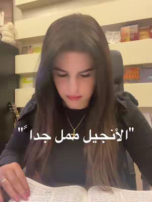 A woman with long, dark hair is seated in front of a bookshelf, reading a book. The text overlay on the cover describes the content.
