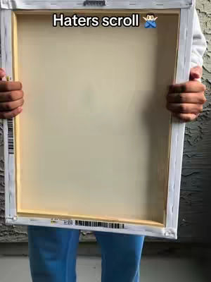 The cover image shows a person holding a framed canvas. The canvas is blank with a neutral color. The person holding it is wearing a white long-sleeved shirt and blue pants. The composition is straightforward, with the frame taking up most of the view and the person's hands anchoring the image from the respective sides.
