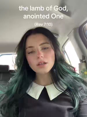 A woman is shown from the chest up, looking slightly upward with a soft expression. She is sitting inside a car. The text overlay on the cover says "the lamb of God, anointed One (Rev 7:10)".