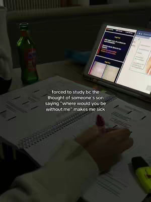 A dimly lit image shows a study setup. In the foreground, a hand with a pen is writing in a spiral notebook. Beside it, a green soda bottle is partially visible. In the background, a tablet displays a website, and there is a laptop open. The overall tone suggests a late-night study session.