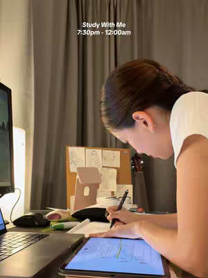 The cover image features a person, likely a student, studying at a desk. The person is seen from the side, facing a tablet where they are writing with a stylus. A laptop, mouse, and other study-related items are also visible on the desk. Behind the person are neutral-toned curtains, creating a cozy and focused study environment. The text overlay indicates a study session titled 'Study With Me' with a specific time frame.