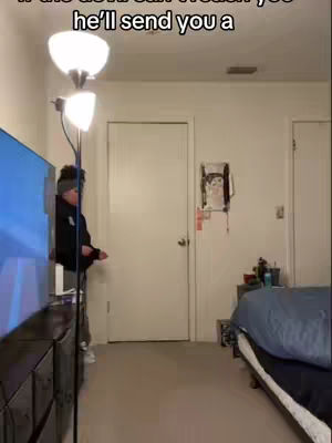The cover image depicts a room with a man partially visible leaning towards a large TV on a dresser. A floor lamp with a domed shade is next to him. A bedroom and door are visible in the background.