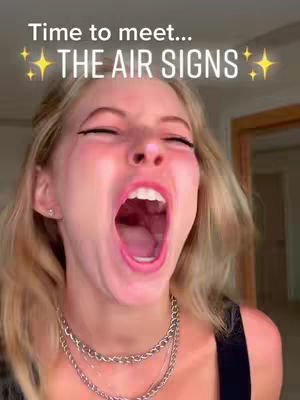 A close-up shot of a woman with her mouth wide open in an exaggerated expression. The woman has blonde hair and is wearing a silver chain necklace.