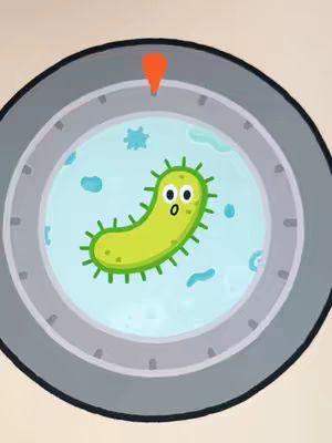The cover image shows a circular dial-like design against a light beige background. Inside the circle is a light blue liquid, containing a green, oval-shaped microorganism with small green spikes. The microorganism has large, surprised-looking eyes. An orange pointer is positioned at the top of the circle.