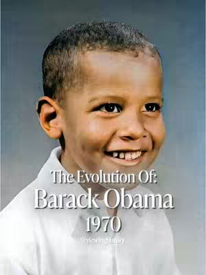 The image is a portrait of a young boy, likely a childhood photo, with a medium skin tone and short, dark hair. The boy is smiling broadly, revealing some teeth, and his eyes are focused, conveying joy. He is wearing a white collared shirt. The background is a gradient, fading from a light color at the top to a darker color at the bottom. Text overlays on the image read 'The Evolution Of: Barack Obama' followed by '1970', placed in the lower part of the image, over the white shirt. The overall composition is warm-toned, with a focus on the boy's face, inviting a sense of nostalgia or historical context.