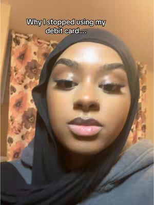 The cover image shows a close-up of a person's face, framed in a headscarf. The person's features are the main focus, with a small nose piercing and makeup visible. The background includes a floral pattern.