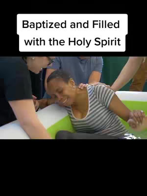 A woman is being baptized, surrounded by other people helping her with her head down at the water. Text at the top says "Baptized and Filled with the Holy Spirit".
