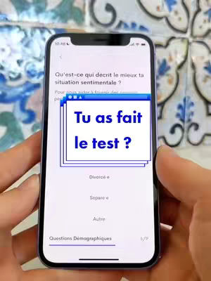 A person's hands hold a smartphone with the screen displaying an app interface with a quiz question about the user's relationship status and a text overlay questioning if the user has taken the test.
