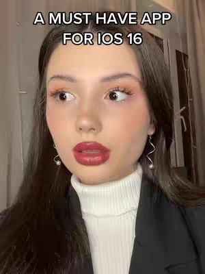 A close-up shot features a fair-skinned woman with dark hair; a text overlay at the top reads, "A MUST HAVE APP FOR IOS 16". She is looking slightly to the left and has red lipstick and earrings.