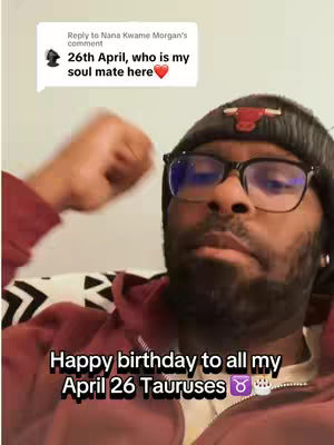 A selfie-style video shows a Black man against a blurred background. He wears a black beanie with a Chicago Bulls logo, glasses, and a maroon shirt. Text overlays include a comment bubble and a birthday message.