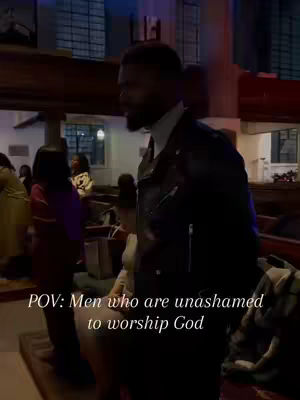 A man in a black leather jacket is walking to the right within a church setting. Other people can be seen in the background, and text overlay is on the lower part of the image.