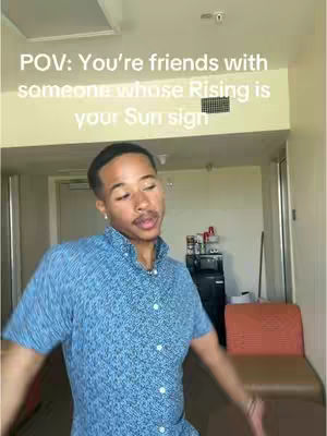 A man is the primary subject, positioned in the foreground. He is wearing a blue patterned shirt that seems to have a button-down design, visible from the collar. The background shows the interior of what appears to be a hotel or similar accommodation, complete with a chair and what could be a small refrigerator or cabinet. White text overlays the image.