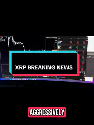 The cover image presents a vertical still from a computer setup. A curved monitor dominates the background, displaying what appears to be a stock trading platform with charts and market data. Overlaying the screen are two text boxes. The top box has a turquoise background, and features white text reading "XRP BREAKING NEWS." Below, a box with a red background and white text reads "AGGRESSIVELY." The overall composition emphasizes breaking financial news.