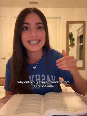 A young woman with braces and long brown hair is centered in the frame, holding an open book. Text overlays at the bottom read, "why did jesus "sweat blood" before His crucifixion?" The background features a simple room setting.