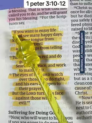 A close-up shot of a Bible page featuring highlighted verses and a yellow pointer in the shape of a graduation cap. The page is open, showing handwritten text in a serif font. Sections are highlighted in yellow, and the pointer is positioned over the text, adding a playful touch to the otherwise serious context.