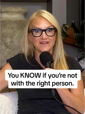 A woman with blonde hair and glasses is holding a microphone and looking directly at the camera. Text overlayed on the image reads, 'You KNOW if you're not with the right person.' The background appears to be a neutral-toned room.