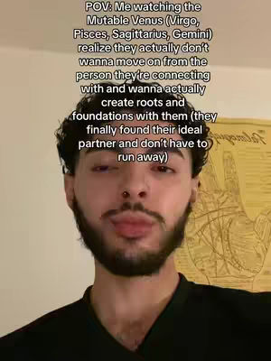 A selfie-style video with the creator in the foreground, the background is blurry. The overlay reads "POV: Me watching the Mutable Venus (Virgo, Pisces, Sagittarius, Gemini) realize they actually don't wanna move on from the person they're connecting with and wanna actually create roots and foundations with them (they finally found their ideal partner and don't have to run away)".