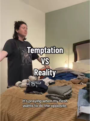 A woman stands with her arms open wide in a bedroom, the text overlays read "TEMPTATION VS REALITY" and "It's praying when my flesh wants to do the opposite."