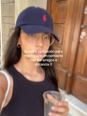 A young woman wearing a navy blue baseball cap and glasses. She's holding a clear glass with a beverage in it. Overlayed on the image is text about an app.