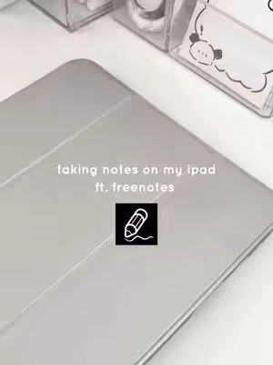 The cover image features an iPad with a gray case, positioned diagonally. Overlayed text reads, 'taking notes on my ipad ft. freenotes'. A black square with a white pencil icon is centered on the iPad.