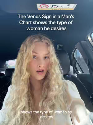 A woman is seated in the driver's seat of a car, looking towards the camera with a somewhat open mouth, as if speaking. The background includes glimpses of the car's interior, and text overlays provide context about astrology and Venus signs.
