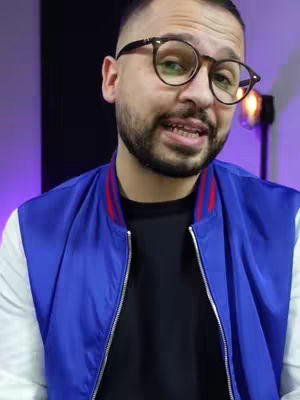The cover image shows a man with short hair, glasses, and a beard, wearing a blue and white jacket. He is in front of a blurred background, looking directly at the camera and speaking.