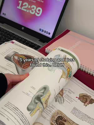 The cover image shows a person holding open a textbook that displays detailed anatomical illustrations, with a laptop and a pink journal in the background.