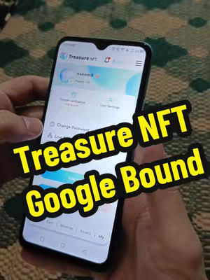 A hand holding a smartphone displaying the Treasure NFT app interface, with a hook overlay on the image, against a blurred background.