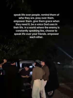 The cover image captures a group of young people near a dark vehicle at night. A text overlay with religious words appears on the screenshot. The lighting is dim, with visibility limited to the immediate surroundings. Over the top of the scene of friend's, the text is shown.