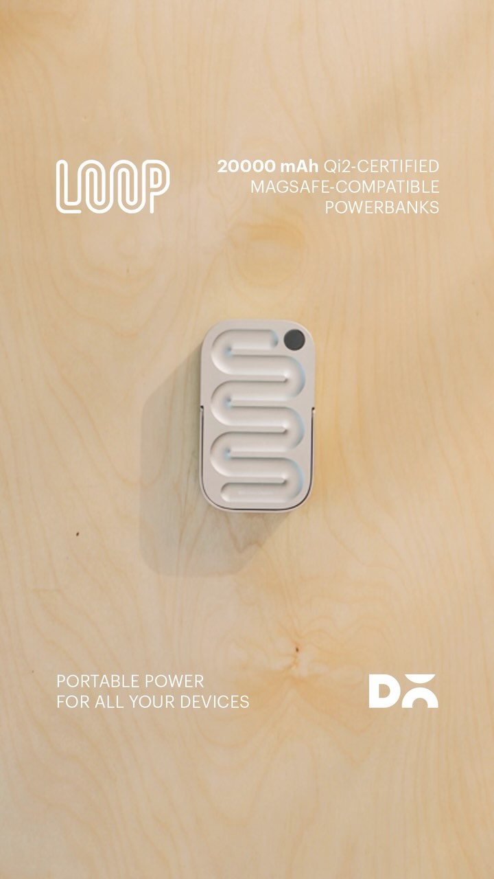 An angled shot focuses on a light-colored power bank with a distinctive wavy design against a light wood grain background. The power bank has a small, dark circular detail at the top. White text labels the product with branding and features.