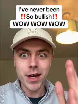 A person is in the foreground wearing a white hat and a light-colored zip-up with a surprised expression. The background is blurred, showing a ceiling light.